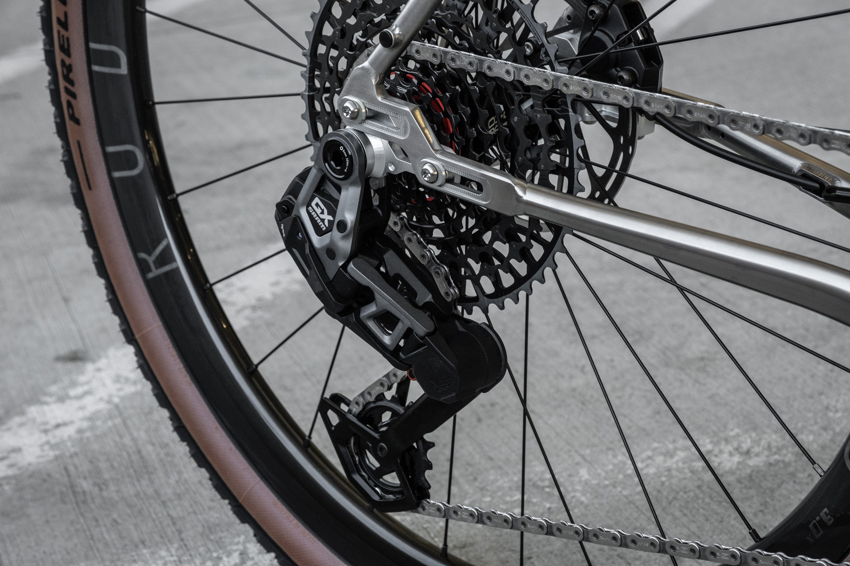 Close-up of a bicycle's rear derailleur and cassette, showcasing the drivetrain components and chain.